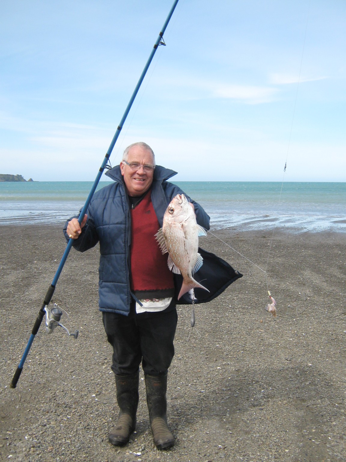 Ian holding a snapper at the beach